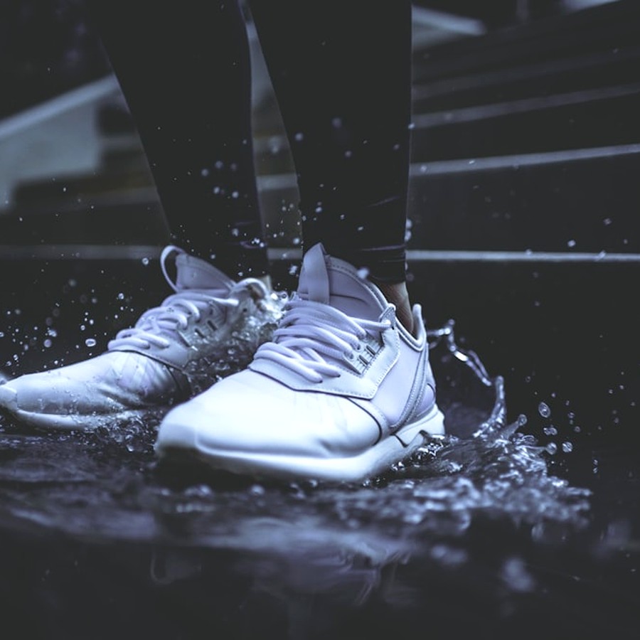 Sneaker blanca salpicada en la calle